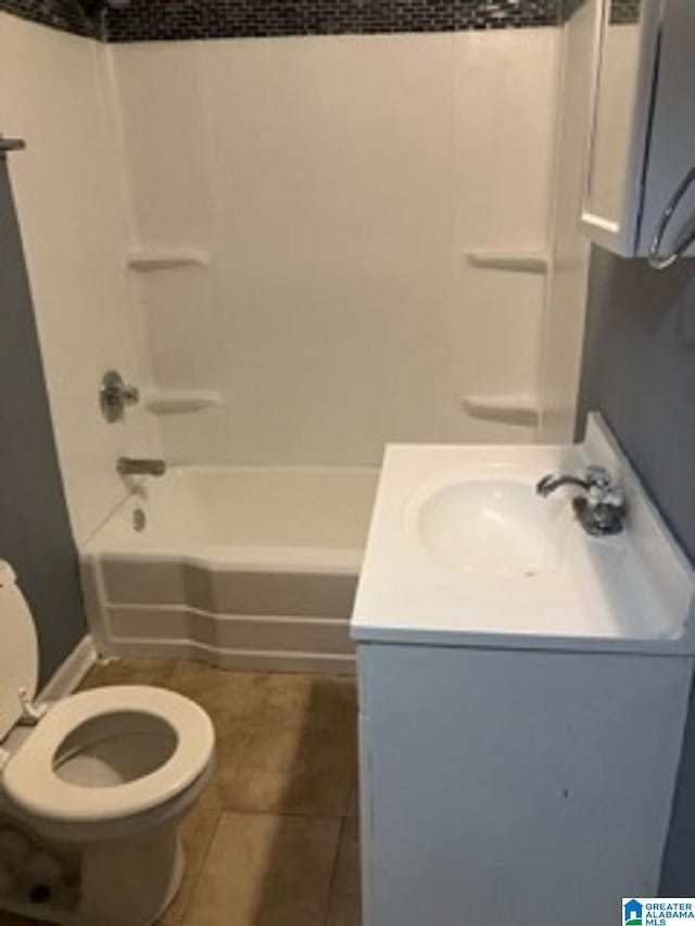bathroom featuring tile patterned floors, toilet, shower / tub combination, and vanity