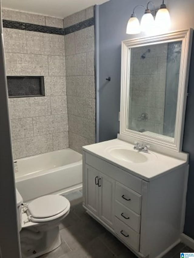 full bathroom with vanity, toilet, tiled shower / bath combo, and tile patterned flooring