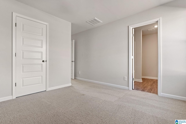 unfurnished room with light carpet