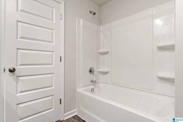 bathroom with shower / bath combination and hardwood / wood-style flooring