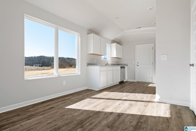 kitchen featuring white cabinetry, lofted ceiling, and dark hardwood / wood-style floors