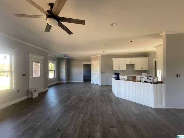 unfurnished living room featuring ceiling fan, ornamental molding, and dark hardwood / wood-style floors