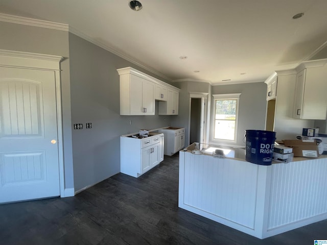 kitchen with dark wood-type flooring, white cabinetry, and ornamental molding