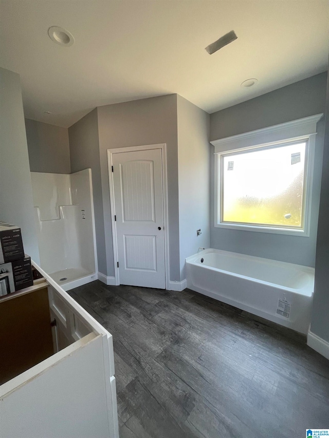 bathroom featuring independent shower and bath and hardwood / wood-style flooring