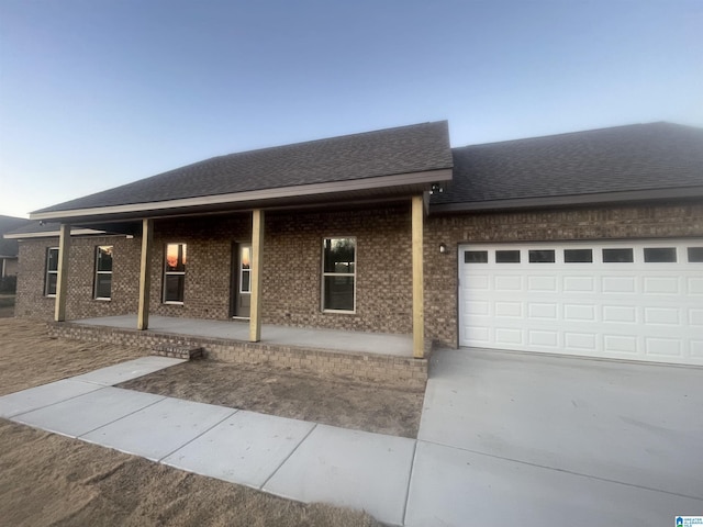 view of front of property featuring a garage and a porch