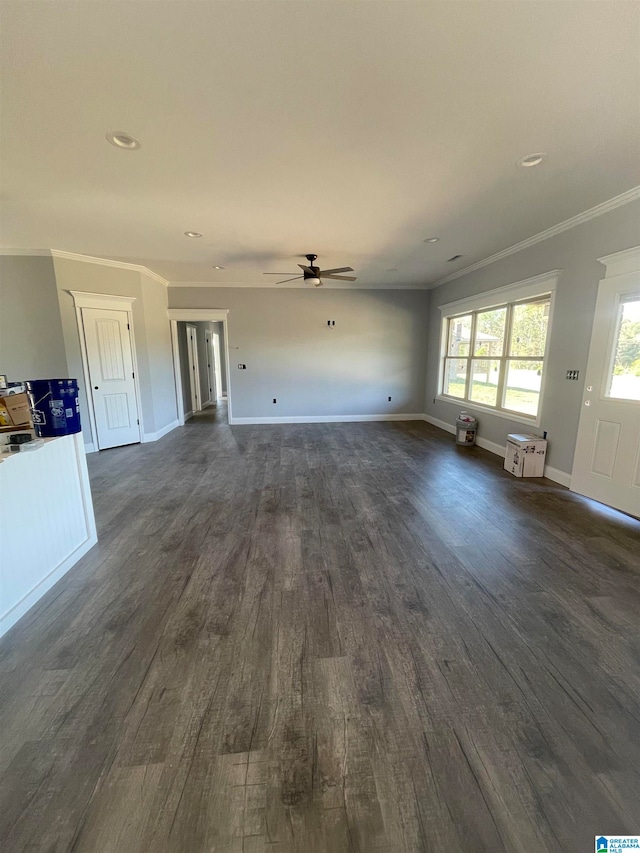 unfurnished living room featuring ceiling fan, dark hardwood / wood-style floors, and ornamental molding