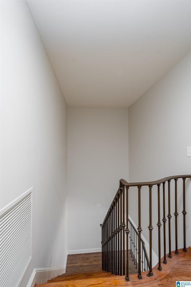 staircase featuring hardwood / wood-style flooring