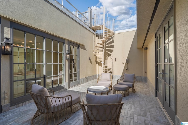 view of patio / terrace with a balcony and french doors