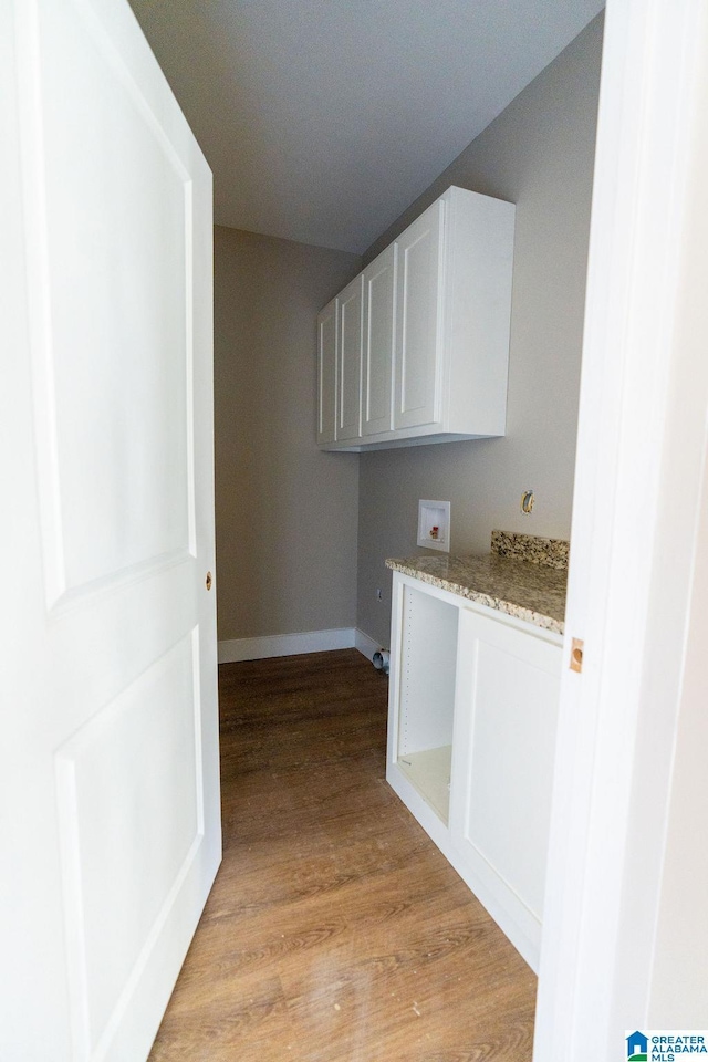 corridor featuring baseboards and light wood-style floors