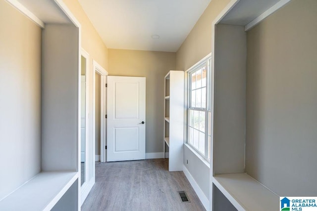 mudroom with visible vents, baseboards, and light wood finished floors