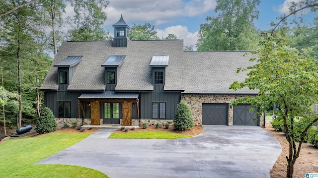 view of front of property with a front yard and a garage