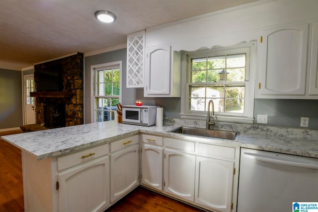 kitchen with white appliances, sink, kitchen peninsula, white cabinets, and dark hardwood / wood-style floors