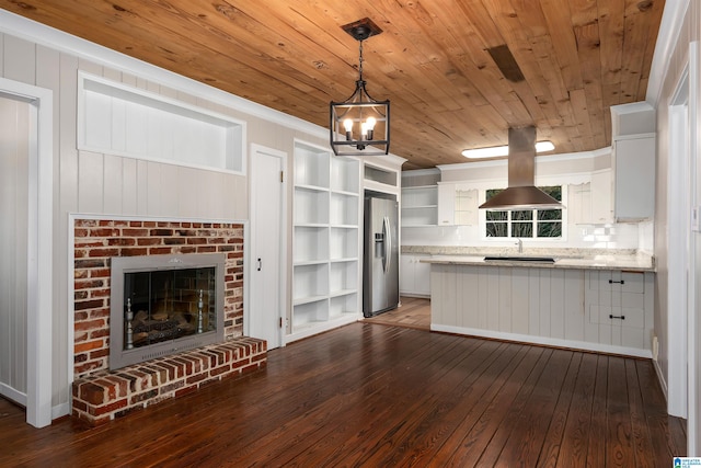 kitchen featuring island exhaust hood, stainless steel fridge, white cabinetry, dark wood-type flooring, and pendant lighting