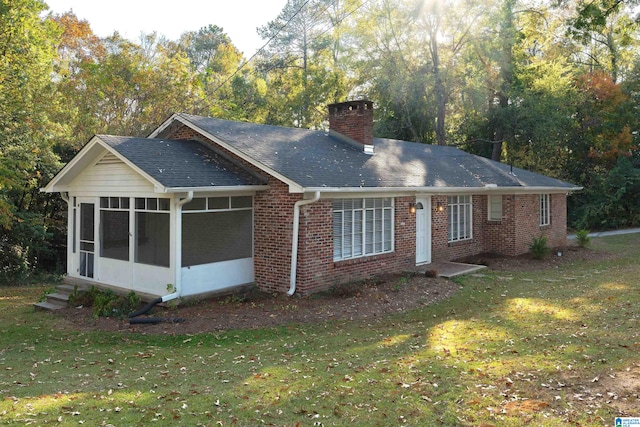 exterior space with a yard and a sunroom