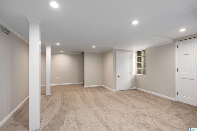 basement featuring crown molding and light carpet