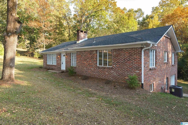 exterior space featuring a yard and central AC unit