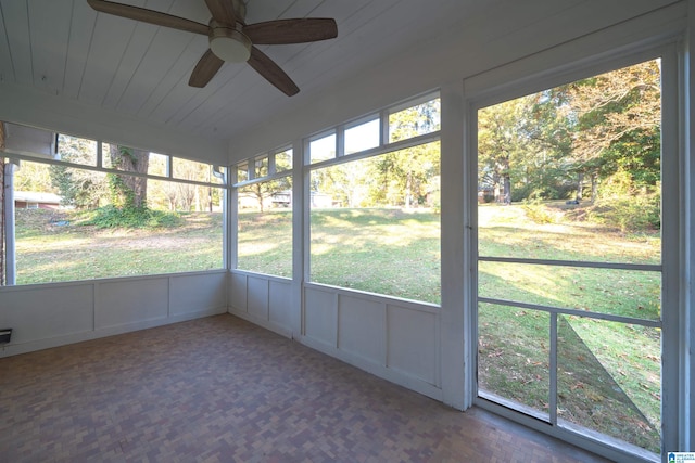 unfurnished sunroom featuring ceiling fan