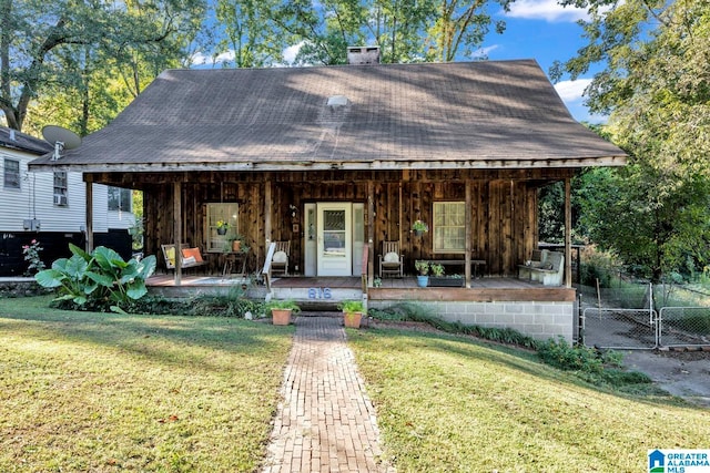 view of front of house with a porch and a front lawn