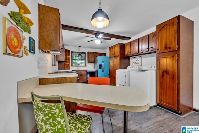 kitchen featuring washer and clothes dryer, stainless steel refrigerator with ice dispenser, wood-type flooring, decorative light fixtures, and ceiling fan