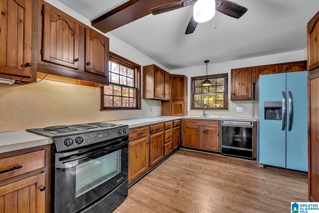 kitchen with plenty of natural light, light wood-type flooring, black appliances, and pendant lighting