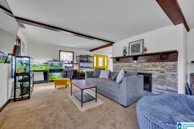 living room with beam ceiling, light carpet, and a fireplace