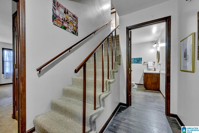 stairs with hardwood / wood-style flooring