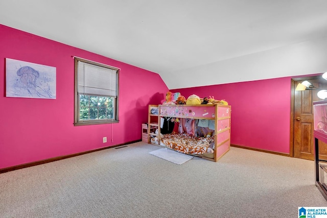 carpeted bedroom featuring lofted ceiling