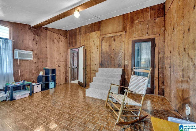 misc room with parquet flooring, beam ceiling, a wall mounted AC, and wooden walls