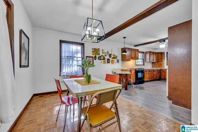 dining room with beamed ceiling, ceiling fan with notable chandelier, and a wealth of natural light