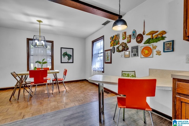 dining area with parquet flooring, beamed ceiling, and an inviting chandelier