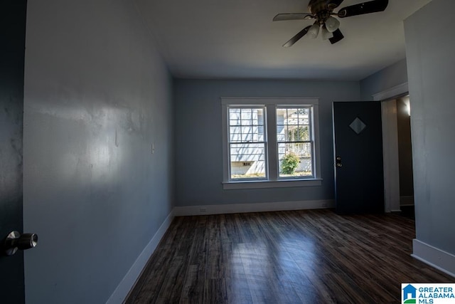 empty room featuring dark wood-type flooring and ceiling fan