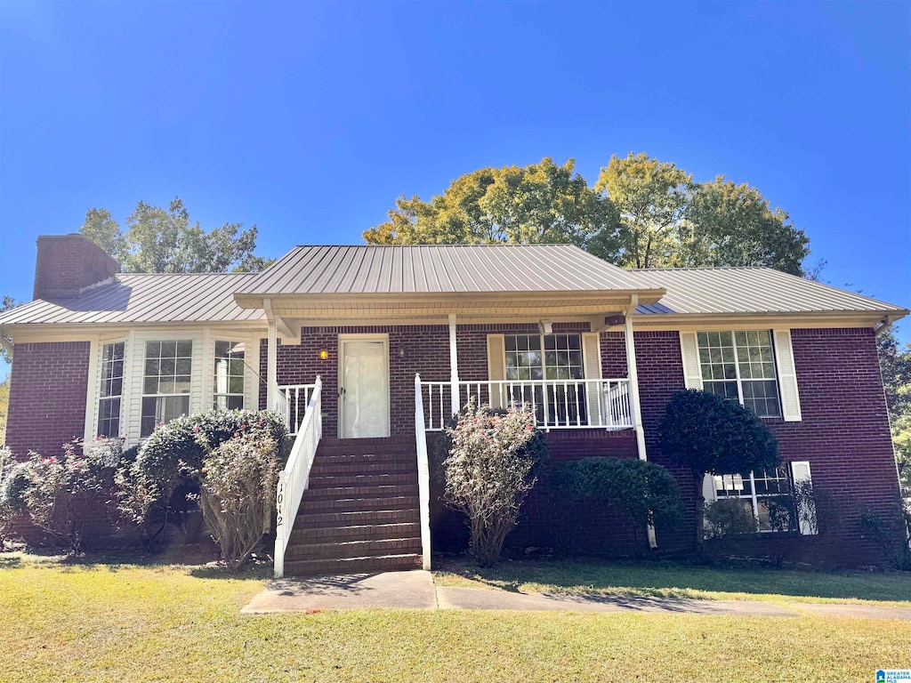 view of front of house with a front yard and a porch