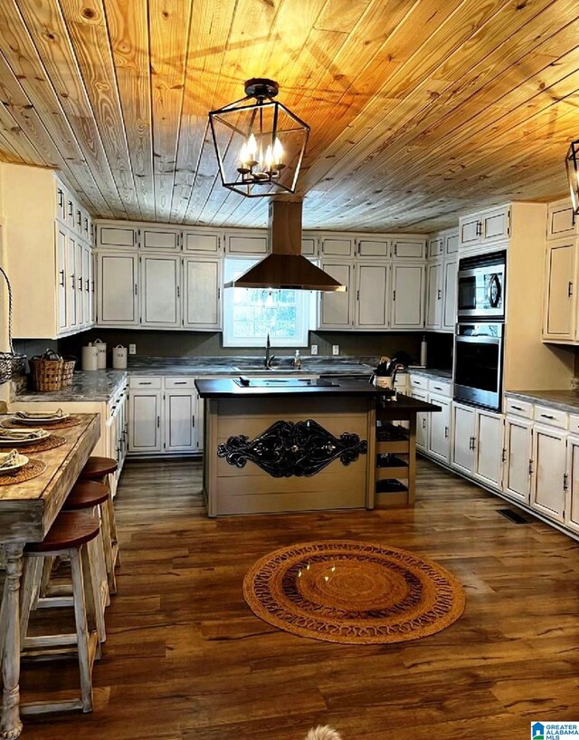765 2nd Ave, Ashland, AL 36251 - kitchen featuring stainless steel appliances, wood ceiling, island range hood, dark wood-style floors, and dark countertops