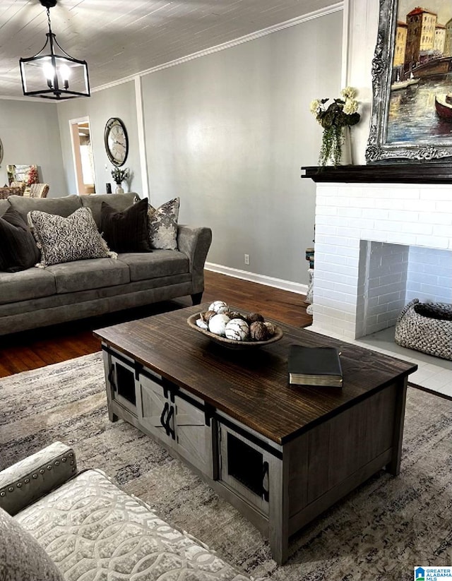 765 2nd Ave, Ashland, AL 36251 - living room featuring crown molding, wood finished floors, baseboards, and a fireplace