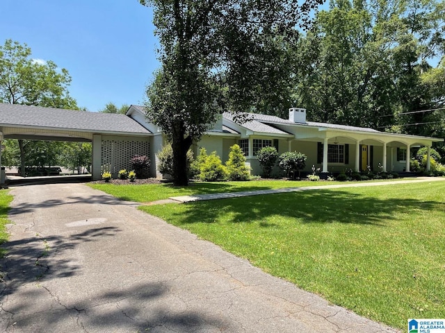 765 2nd Ave, Ashland, AL 36251 - ranch-style home featuring a front lawn, a chimney, driveway, and an attached carport