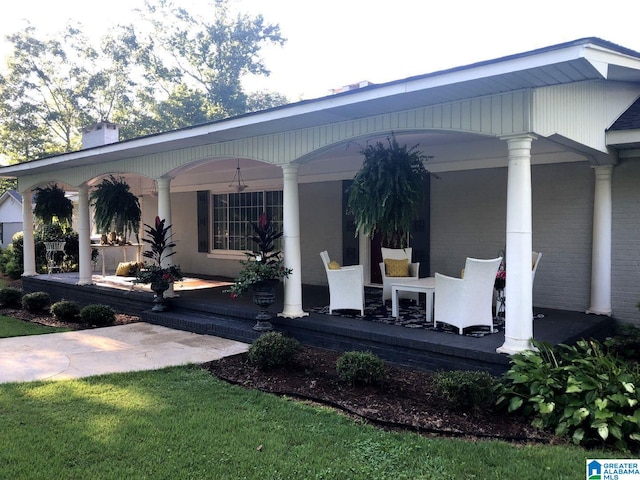 exterior space with covered porch and a lawn