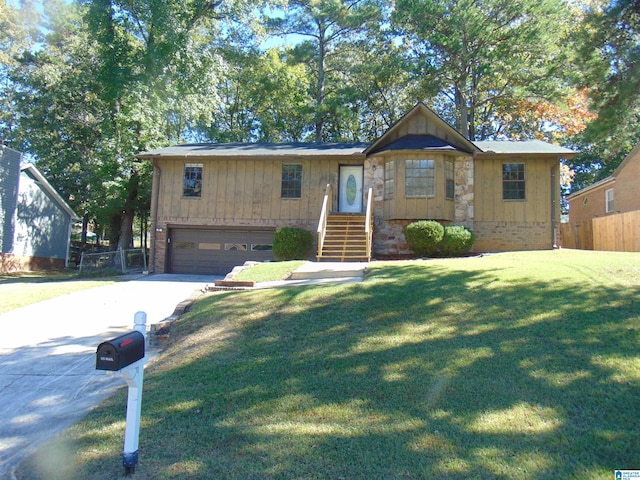 view of front of home featuring board and batten siding, fence, a front yard, driveway, and an attached garage