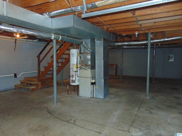 unfinished basement with water heater, stairway, and heating unit