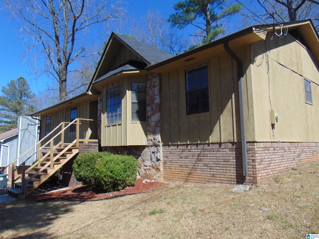 view of side of home with brick siding and board and batten siding