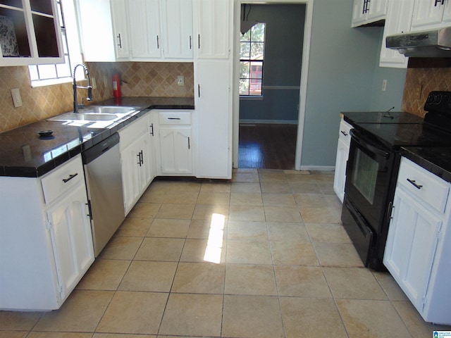 kitchen featuring dark countertops, under cabinet range hood, stainless steel dishwasher, black / electric stove, and a sink