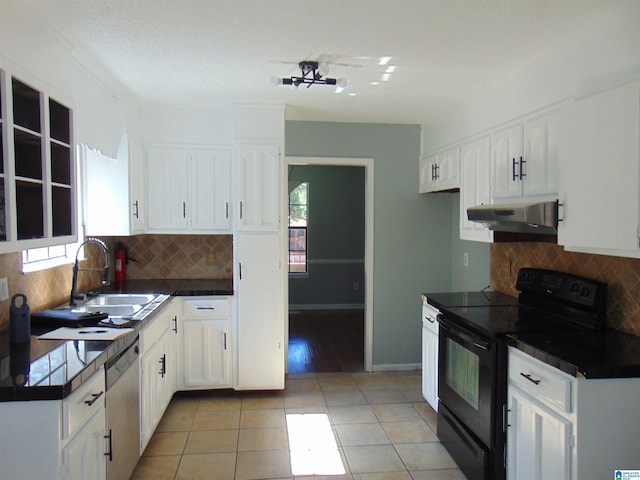 kitchen featuring under cabinet range hood, dark countertops, black range with electric cooktop, and stainless steel dishwasher