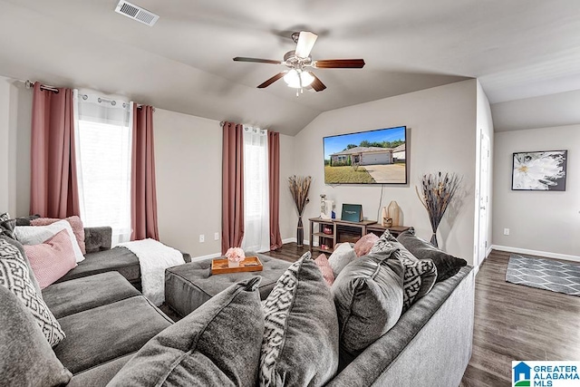 living room featuring ceiling fan, a healthy amount of sunlight, vaulted ceiling, and dark hardwood / wood-style floors