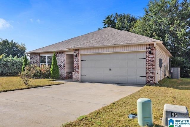 ranch-style home featuring a garage, a front lawn, and central air condition unit