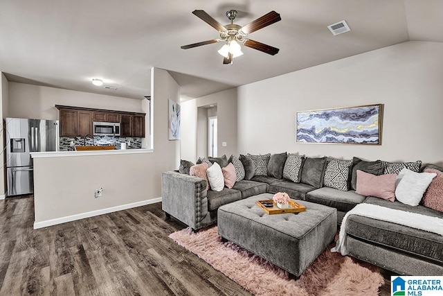 living room featuring ceiling fan, vaulted ceiling, and dark hardwood / wood-style floors