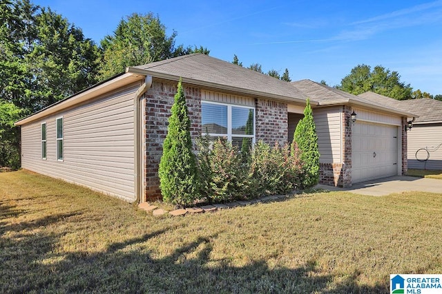 view of front of home with a front yard and a garage