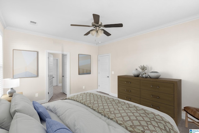 bedroom with crown molding, ensuite bathroom, light colored carpet, and ceiling fan