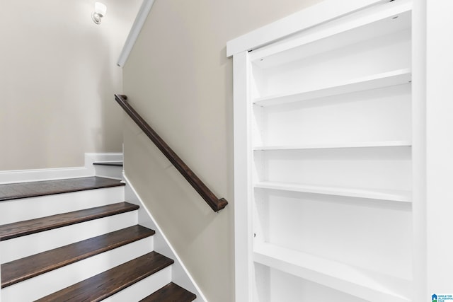 staircase with hardwood / wood-style flooring