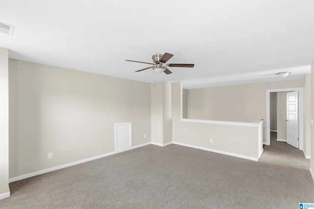 carpeted spare room featuring ceiling fan