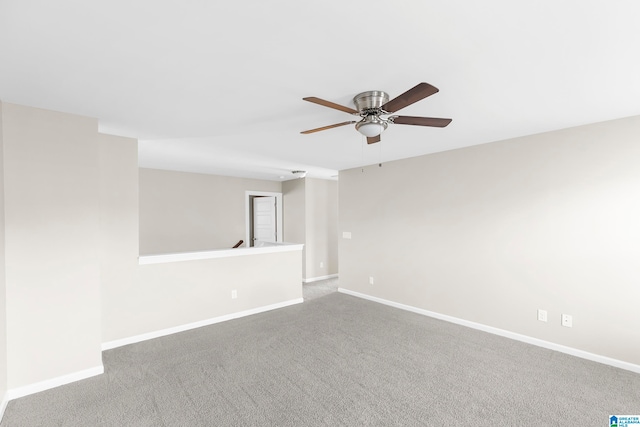 empty room with ceiling fan and carpet floors