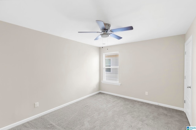 empty room with ceiling fan and light colored carpet